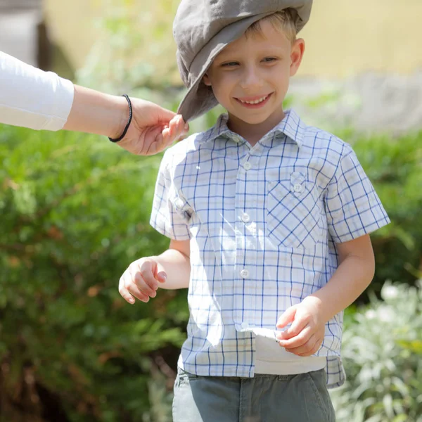 Cute fair-haired boy is playing outside. — Stock Photo, Image