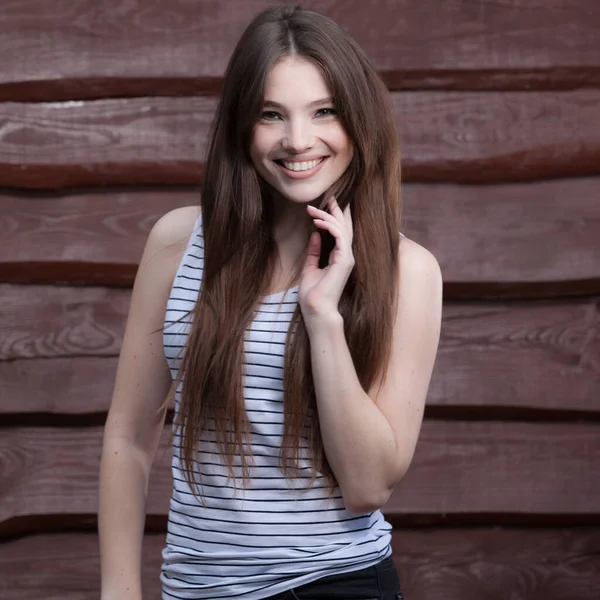 Portrait of beautiful young girl on wooden background. — Stock Photo, Image