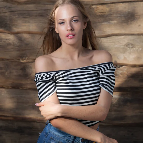 Portrait of beautiful young girl on wooden background. — Stock Photo, Image