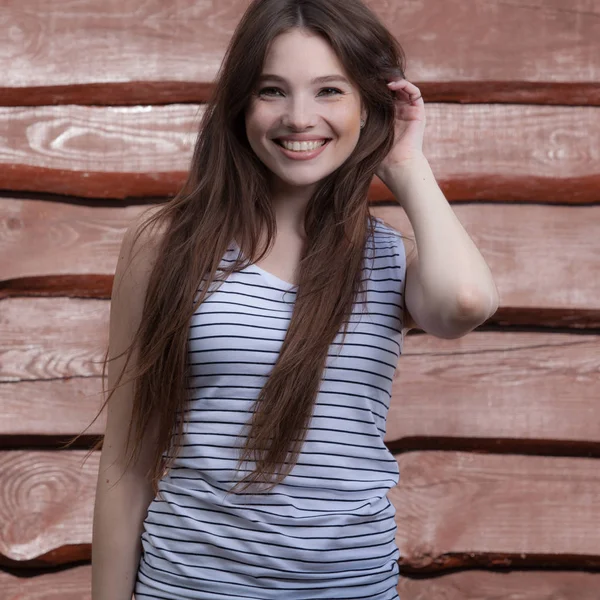 Portrait of beautiful young girl on wooden background. — Stock Photo, Image