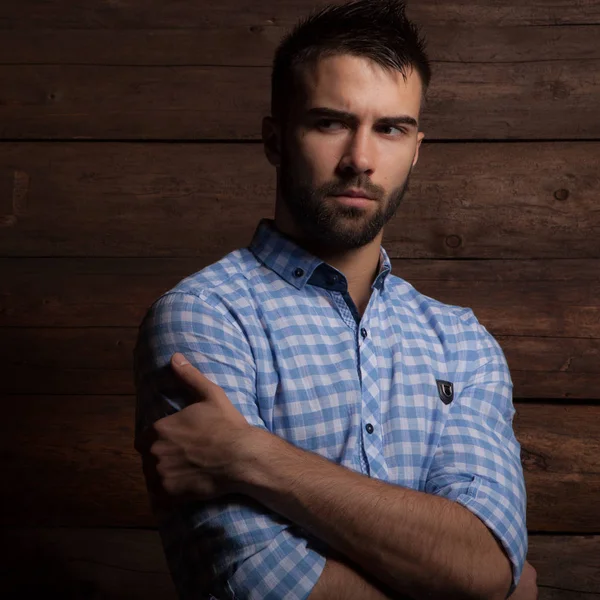 Portrait of handsome young man on wooden background. — Stock Photo, Image