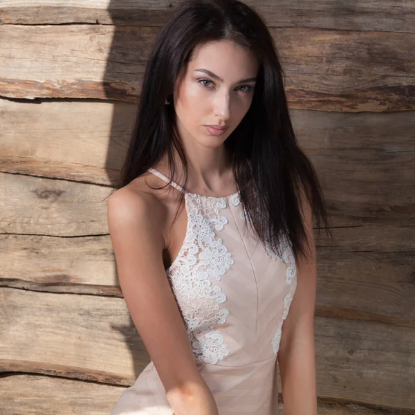 Portrait of beautiful young girl on wooden background. — Stock Photo, Image