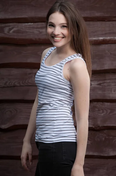 Portrait of beautiful young girl on wooden background. — Stock Photo, Image