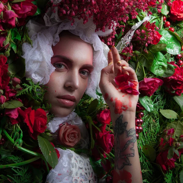 Female portrait in fairy tale stylization surrounded with natural flowers. — Stock Photo, Image