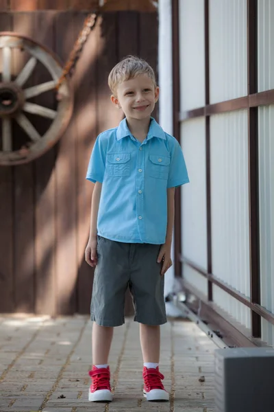 Cute fair-haired boy is playing outside. — Stock Photo, Image