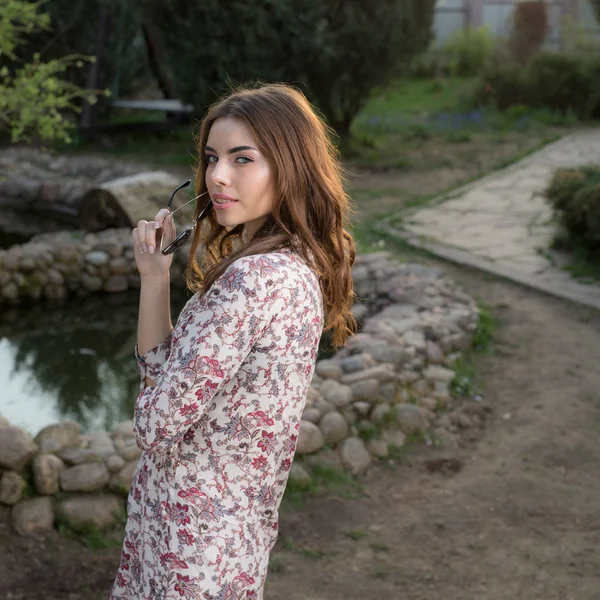 Portret van een mooi jong meisje in de zomertuin. — Stockfoto