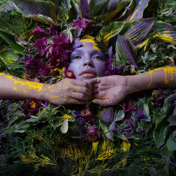 Female portrait in fairy tale stylisation surrounded with natural plants and flowers. — Stock Photo, Image