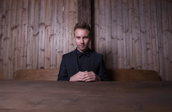 Portrait of handsome young man on wooden background. — Stock Photo, Image