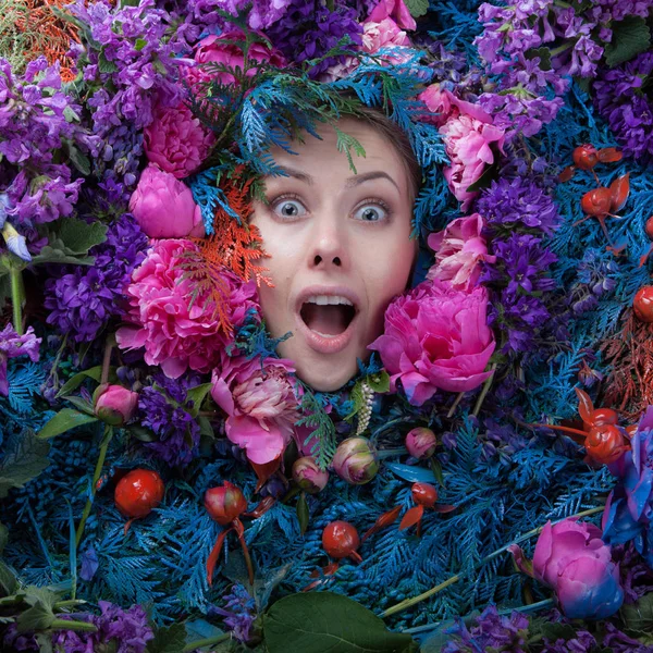 Female portrait in fairy tale stylization surrounded with natural flowers. — Stock Photo, Image