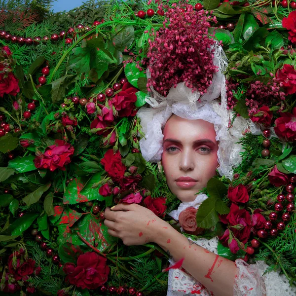 Portrait féminin dans la stylisation de conte de fées entouré de fleurs naturelles . — Photo