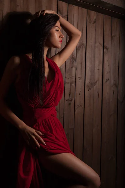 Portrait of beautiful young girl on wooden background. — Stock Photo, Image