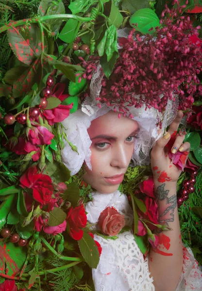 Female portrait in fairy tale stylization surrounded with natural flowers. — Stock Photo, Image