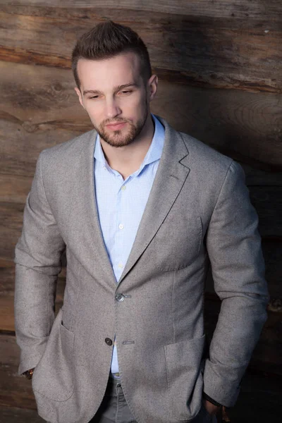 Portrait of handsome young man on wooden background. — Stock Photo, Image