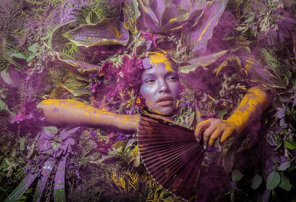 Retrato feminino em estilo conto de fadas rodeado de plantas e flores naturais . — Fotografia de Stock