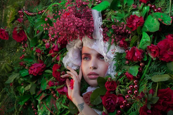 Female portrait in fairy tale stylization surrounded with natural flowers. — Stock Photo, Image