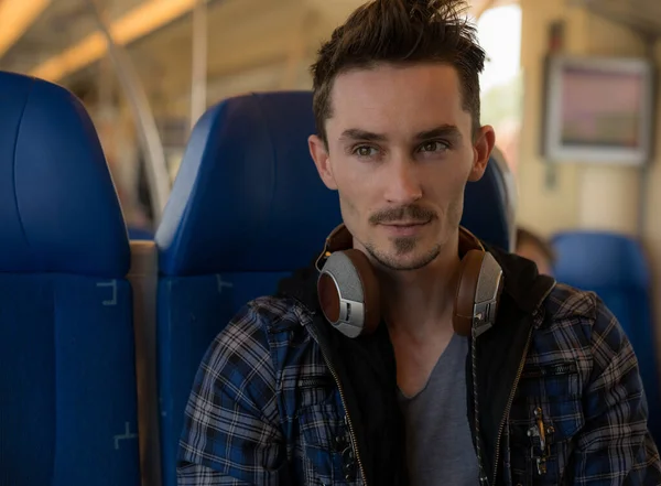 Young handsome man rides a train. — Stock Photo, Image