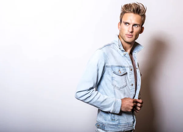 Handsome young man in jeans jacket pose in studio. — Stock Photo, Image