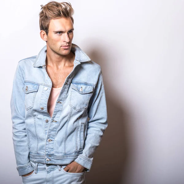 Handsome young man in jeans jacket pose in studio. — Stock Photo, Image