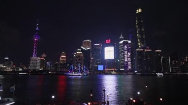 SHANGHAI, CHINA - APRIL 03, 2019: Modern central streets of Shanghai and high-rise buildings at night time. Slow Motion Footage.