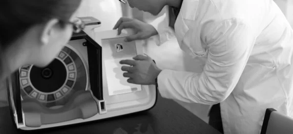 Doctors hands close-up against modern health diagnostic equipment. — Stock Photo, Image