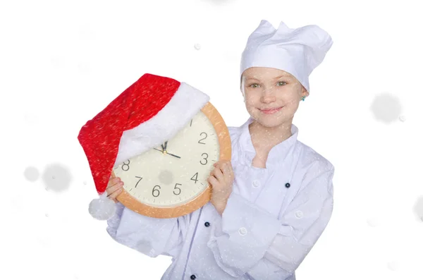 Fille avec horloge, chapeau de Père Noël et neige — Photo