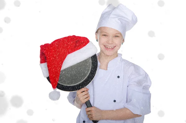 Smiling girl, frying pan and Santa hat with snow — Stock Photo, Image