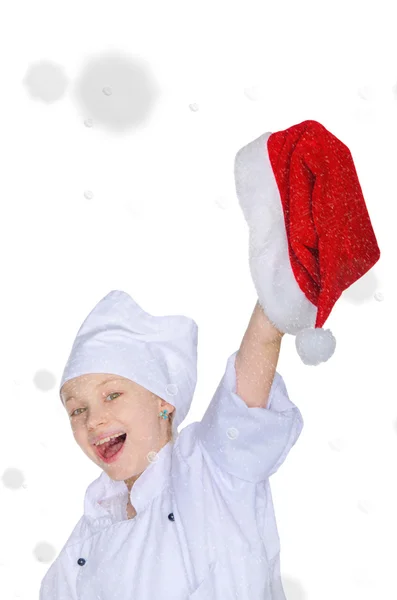 Fille en costume de chef et chapeau de Père Noël sur la neige — Photo