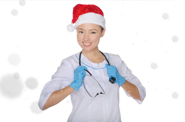 Smiling asian doctor and Santa hat with snow — Stock Photo, Image