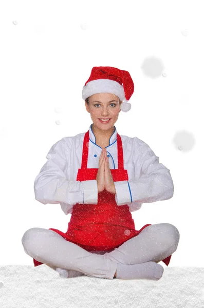 Chef in hat of Santa Claus doing yoga with snow — Stock Photo, Image