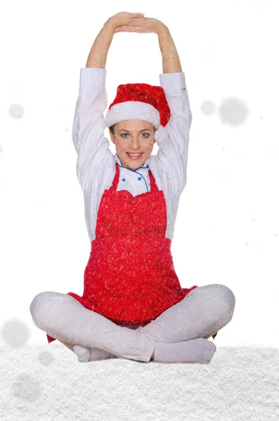 Bela cozinheira em chapéu de Papai Noel com neve — Fotografia de Stock