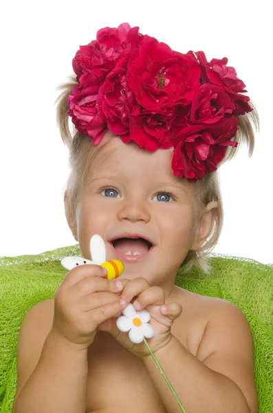 Smiling little girl with flowers — Stock Photo, Image