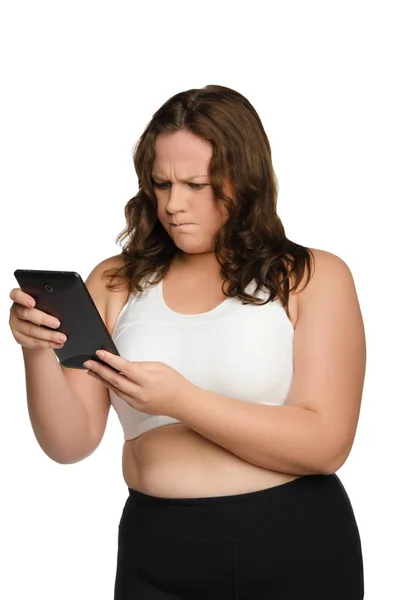 Angry fat athletic woman with tablet — Stock Photo, Image