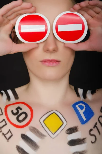 Beautiful woman with painted road signs — Stock Photo, Image