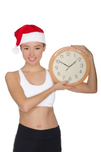 Glückliche asiatische Frauen in einem Weihnachtsmannhut mit einer Uhr — Stockfoto