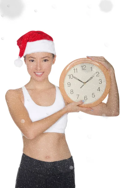 Sorrindo asiático mulheres no um Papai Noel chapéu com um relógio — Fotografia de Stock