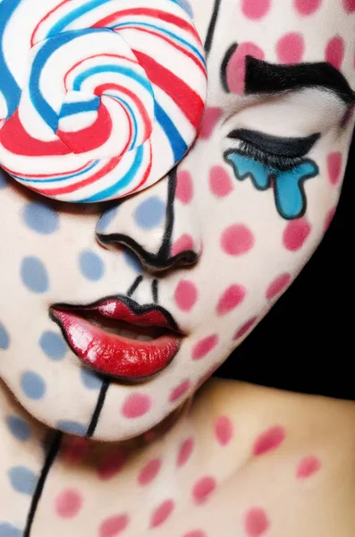 Face art with a lollipop on the face — Stock Photo, Image