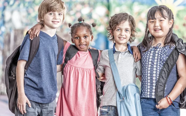 Happy multi ethnic classmates embracing in schoolyard, happiness — Stock Photo, Image