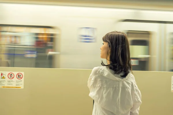 Молода жінка чекає на поїзд метро — стокове фото