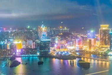 MACAU, CHINA - APRIL 2014: City skyline at night. Macau is a fam clipart