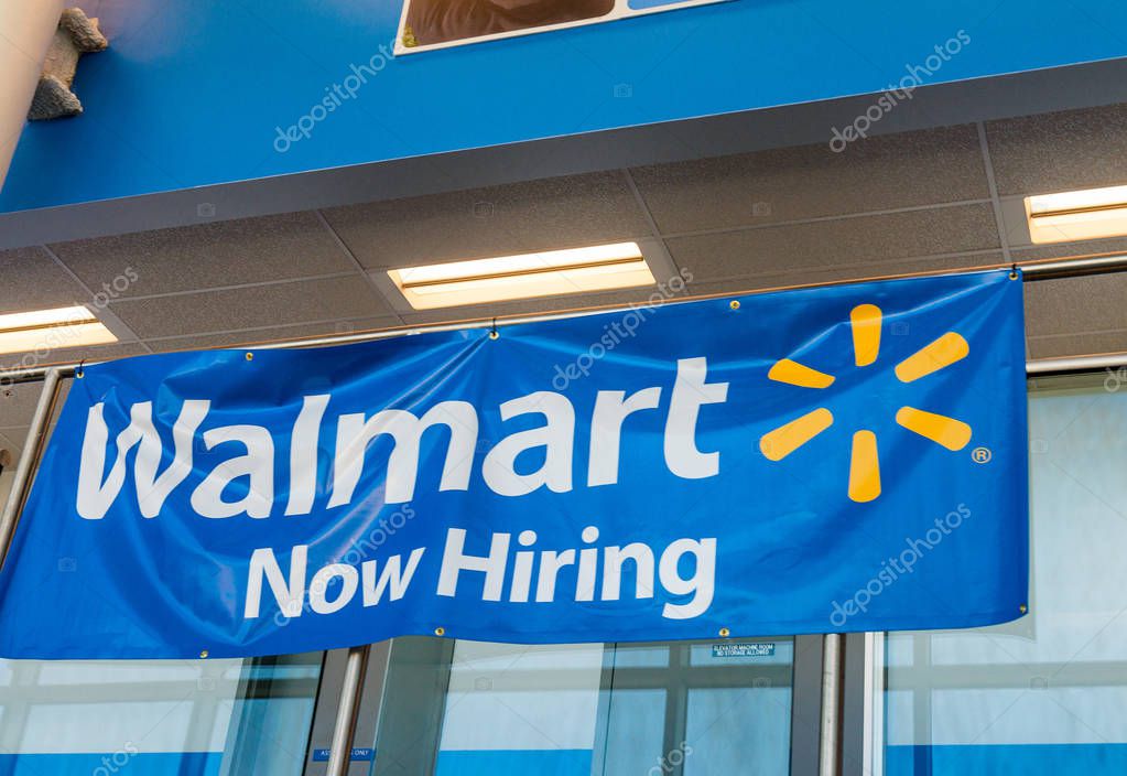 BOSTON - OCTOBER 18, 2015: Walmart entrance with Now Hiring sign. Walmart is the largest retailer in the USA, based in Arkansas.