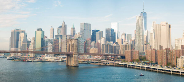 NEW YORK CITY - OCTOBER 22, 2015: Lower Manhattan skyline from Manhattan Bridge. New York attracts 50 million people annually.