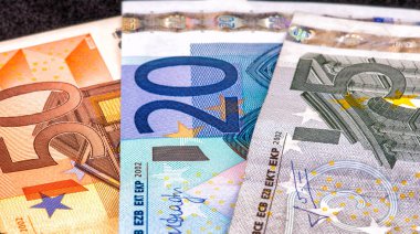 Five, Twenty and Fifty Euro bills on black background clipart