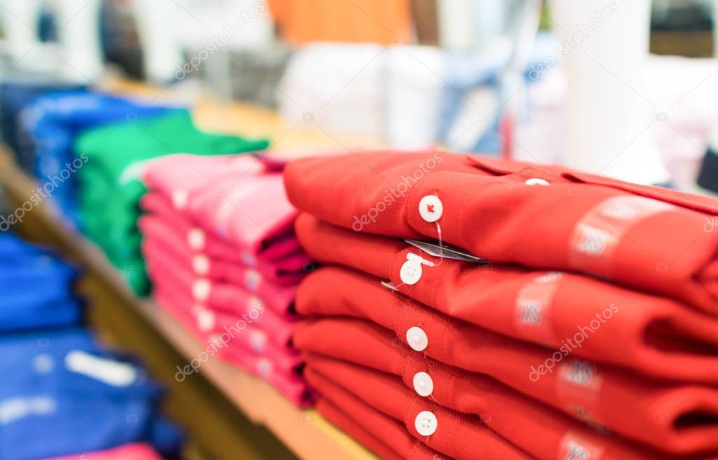 Row of colourful shirts in a shop