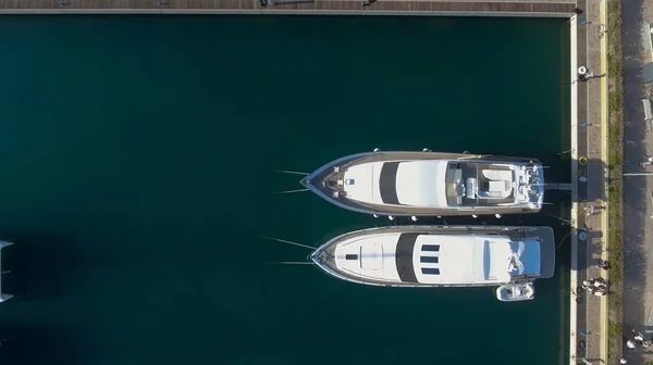 Overhead aerial view of anchored boats in a small port