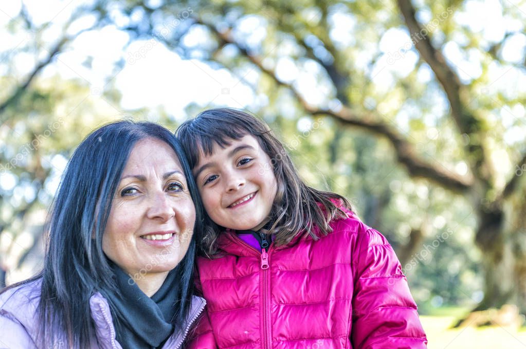 Mother and daughter embracing on a beautiful park