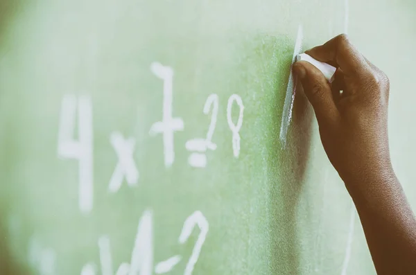 African child hand writing at chalkboard — Stock Photo, Image