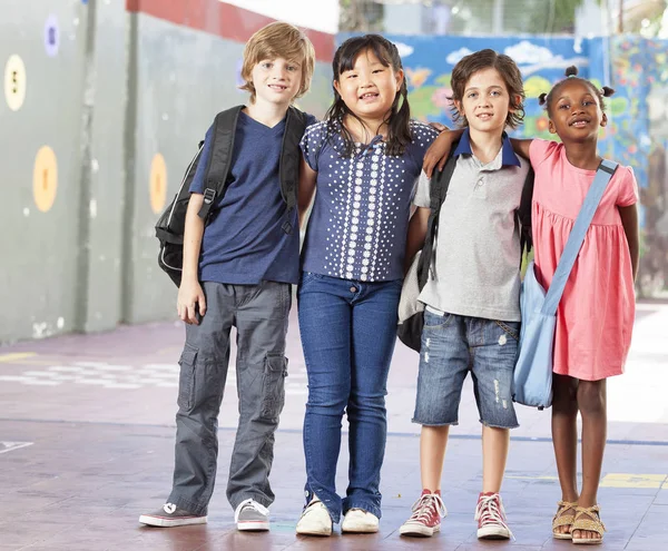 Multiethnic group of schoolchildren playing at school — Stock Photo, Image