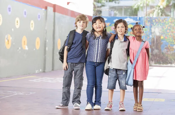 Multietnisk grupp av skolbarn spela i skolan — Stockfoto