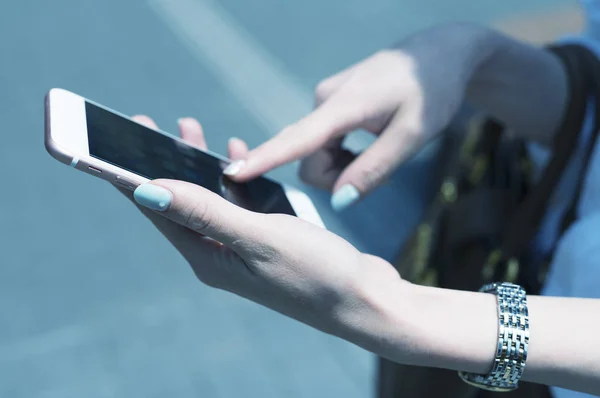 Beautiful woman tapping mobile phone screen — Stock Photo, Image