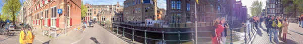 Amsterdam - April 2015: Toeristen lopen langs de stadsstraten. De ci — Stockfoto